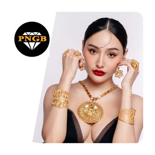 Model wearing PNGB gold jewelry and pendant set